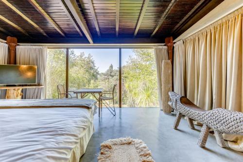 a bedroom with a bed and a large window at Quinta de Santa Luzia in Santo Tirso