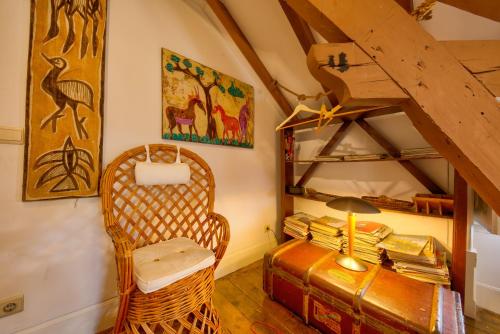 a room with a chair and a table with a desk at Adore Portugal Coimbra Guest House in Coimbra