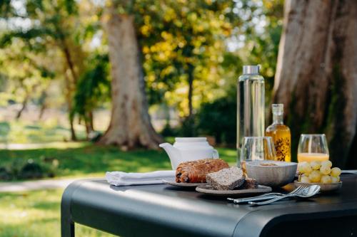 a table with food and a bottle of orange juice at Hôtel Domaine de Biar in Montpellier