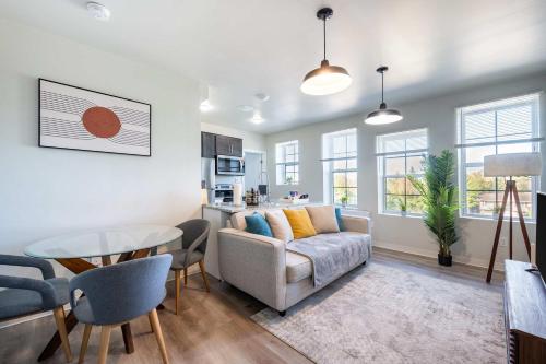a living room with a couch and a table at 2BR Exclusive Retreat Near Henry Ford in Detroit