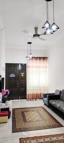 a living room with a couch and a window at Ayash homestay in Temerloh