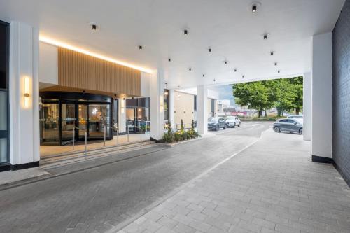 an empty street with cars parked in a building at Holiday Inn Leicester City by IHG in Leicester