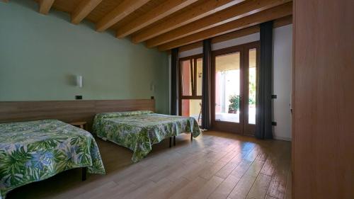 Postel nebo postele na pokoji v ubytování Agriturismo Ai Tre Fienili