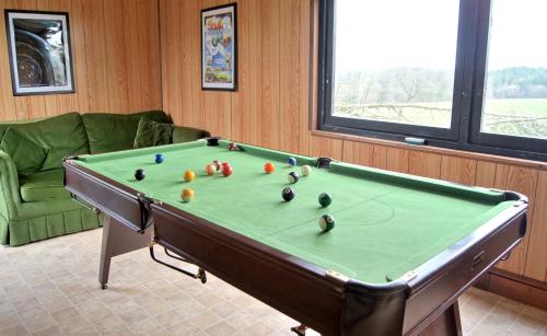 a pool table with balls on it in a room at The Long Barn nr Huntsham in Tiverton