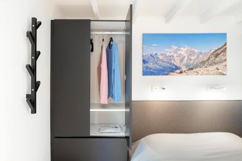 a bedroom with a bed and a painting on the wall at Superb Chalet Monterosa in Anzino