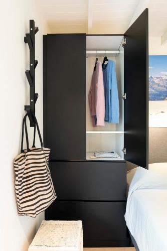a black cabinet in a bedroom with a bed at Superb Chalet Monterosa in Anzino