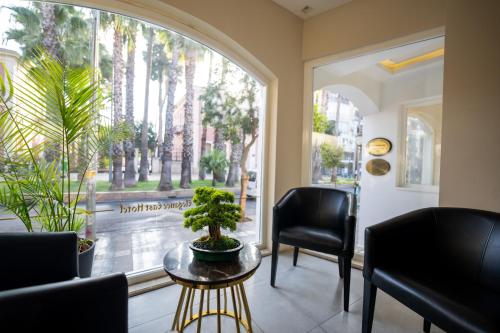 a room with two chairs and a table and a window at Elegance East Hotel in Antalya