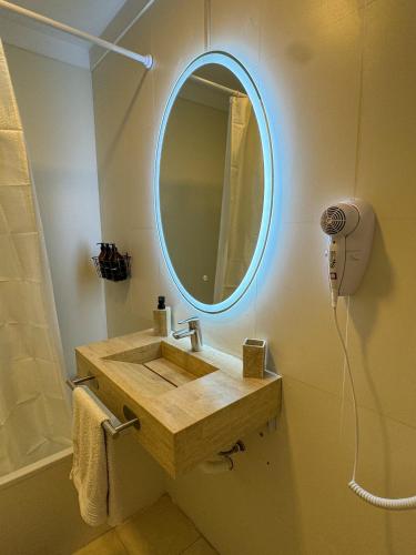 a bathroom with a sink and a mirror on the wall at Foster Studio - Nicaragua in Buenos Aires