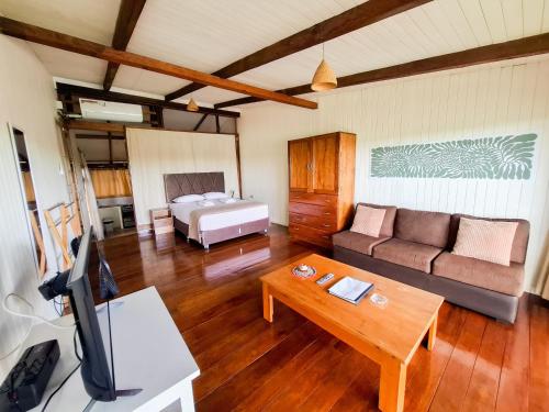 a living room with a couch and a bed at Boulevard 251 Riverside Apartments in Iquitos