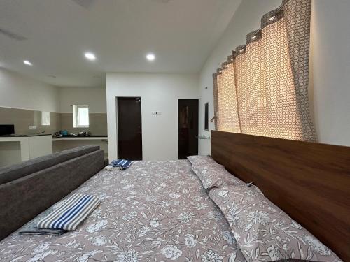 a bedroom with a large bed in a room at HOMESTAY - AC 1 BHK STUDIO NEAR AlRPORT in Chennai