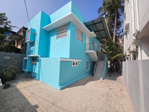 a blue building with stairs on the side at HOMESTAY - AC 1 BHK STUDIO NEAR AlRPORT in Chennai