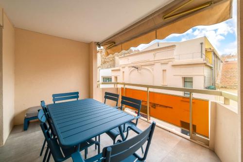 une table bleue et des chaises sur un balcon dans l'établissement REF 1967 - Cannes Center - Apartment for rent, à Cannes