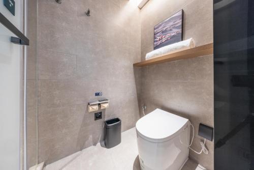 a small bathroom with a toilet and a sink at Atour Hotel Nanjing South Railway Station North Square in Jiangning