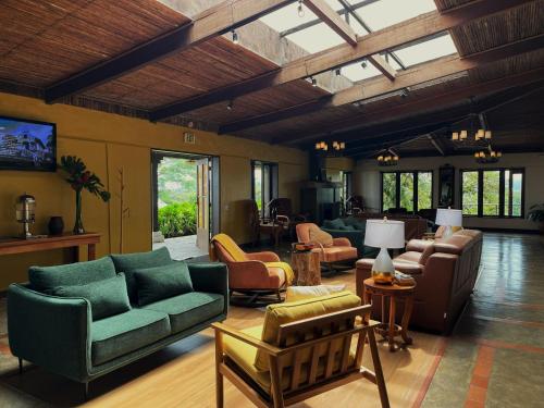 a living room with couches and chairs at Villa Blanca Cloud Forest Hotel & Retreat in San Ramón