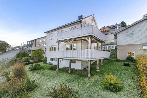 a large house with a balcony on a yard at Villa in central Narvik! in Narvik