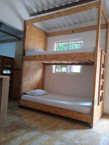two bunk beds in a room with a window at Hostal La Guaca in Cartagena de Indias