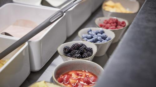 a row of bowls of fruit on a counter at Der Brandstetterhof - Adults only in Stans