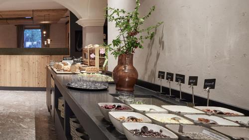 a buffet with many plates of food on a counter at Der Brandstetterhof - Adults only in Stans