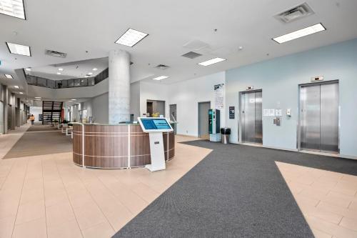 a lobby of a hospital with a reception counter at Bright Suites Finch West steps to Metro in Toronto