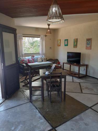 a living room with a table and a couch at Casa na linda praia de Jericoacoara in Jericoacoara