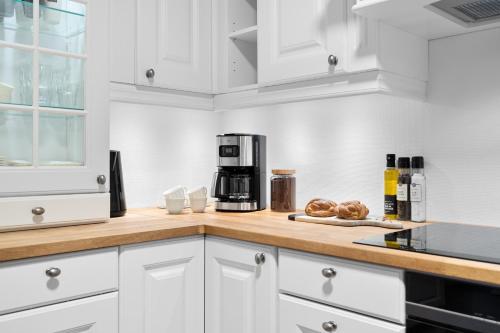 a kitchen with a counter with a coffee maker and bread at Arctic Aurora Apartment I SAUNA I Family & Groups in Tromsø