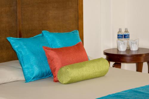 a group of pillows sitting on top of a bed at Hesperia Playa el Agua in El Agua