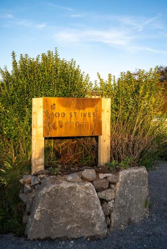 a wooden bench sitting on top of a pile of rocks at POD St Ives - LUXURY GLAMPING ACCOMMODATION in St Ives