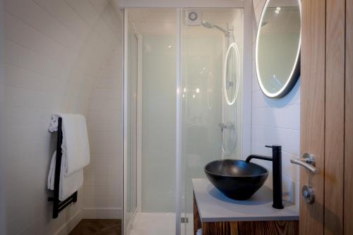 a bathroom with a bowl sink and a shower at POD St Ives - LUXURY GLAMPING ACCOMMODATION in St Ives