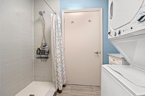 a bathroom with a shower with a shower curtain at Bright Suites Finch West steps to Metro in Toronto
