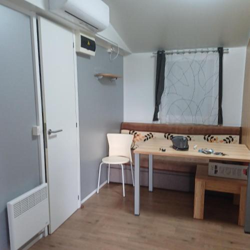 a room with a table and a chair and a window at Vila Matias in Vodice