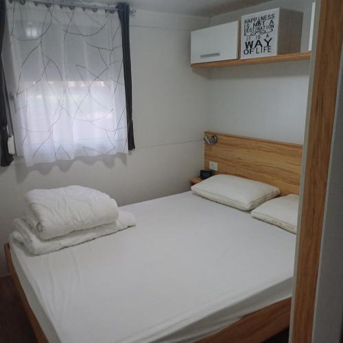a bedroom with a bed with two pillows on it at Vila Matias in Vodice