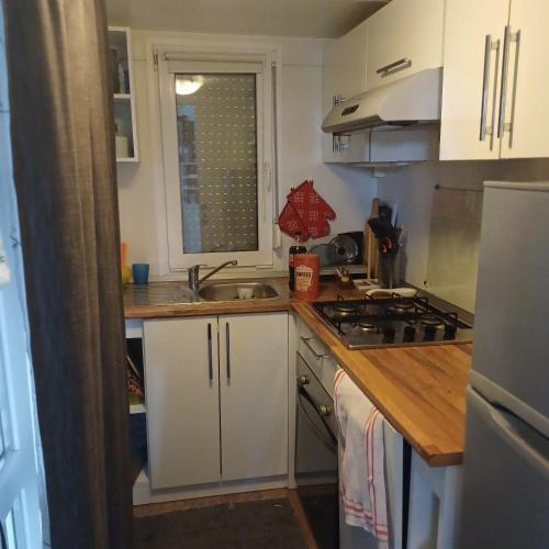a kitchen with white cabinets and a sink at Vila Matias in Vodice