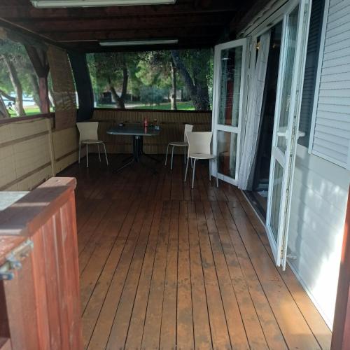 a screened in porch with a table and chairs on it at Vila Matias in Vodice