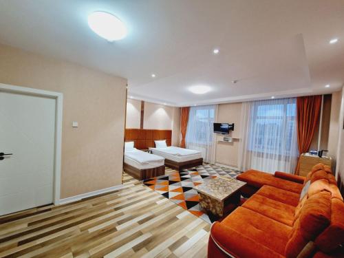 a large living room with a couch and a table at Copper hotel Erdenet city Mongolia in Erdenet