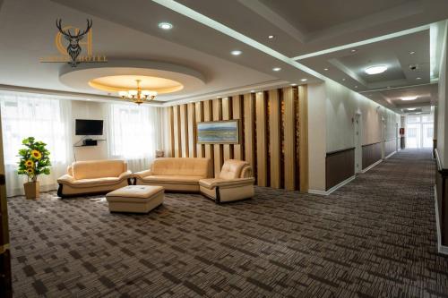 a lobby with couches and chairs in a building at Copper hotel Erdenet city Mongolia in Erdenet