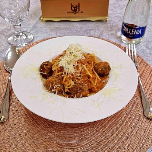 a plate of spaghetti and meatballs on a table at Copper hotel Erdenet city Mongolia in Erdenet