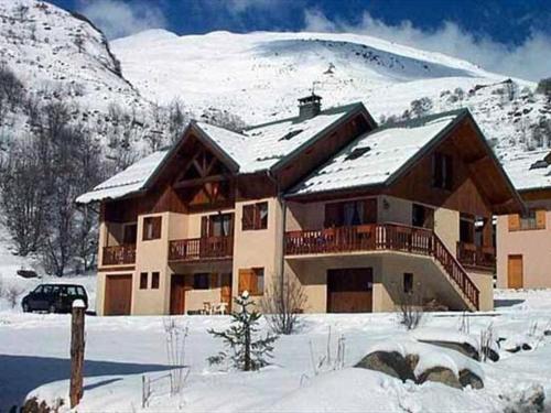 un grand bâtiment avec de la neige au sommet d'une montagne dans l'établissement Triplex cosy à Valloire - 8 pers, animaux admis, parking et wifi - FR-1-263-178, à Valloire