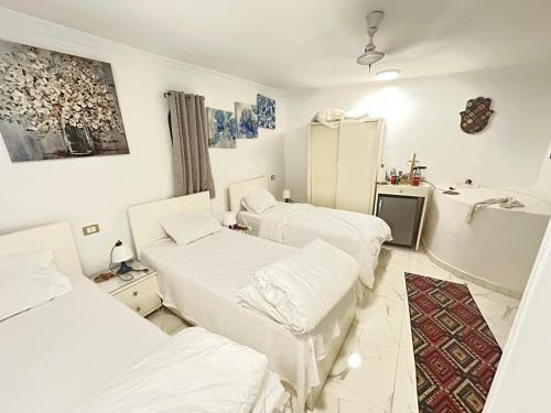 a hospital room with three beds and a tub at White House in Aswan