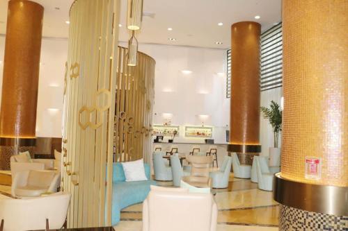 a lobby with white chairs and a bar at Deluxe Studio Ocean View Premium Amenities in Sunny Isles Beach