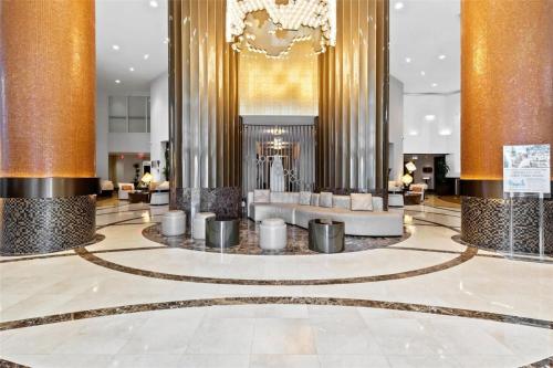 a lobby of a hotel with columns and couches at Ocean View Luxurious Studio Premium Amenities in Sunny Isles Beach