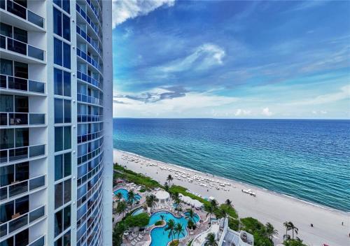 a view of the beach and the ocean from a building at Deluxe Studio Ocean View Premium Amenities in Sunny Isles Beach