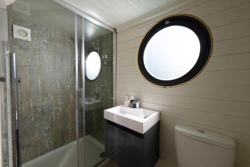 a bathroom with a sink and a shower at Carbis Bay and Spa Hotel in St Ives