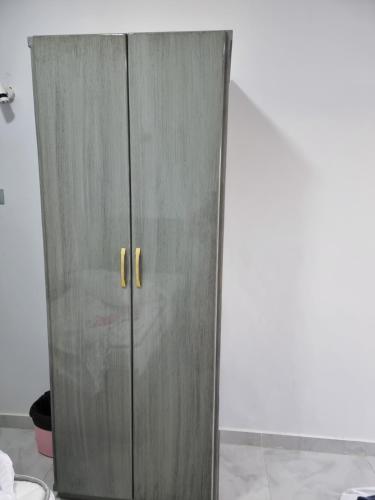 a gray cabinet with two doors in a room at PANORAMIC BABA DOoL in Aswan