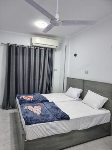 a bedroom with a bed with a blue blanket on it at PANORAMIC BABA DOoL in Aswan