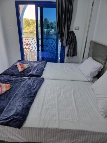a bedroom with a bed with a view of a window at PANORAMIC BABA DOoL in Aswan