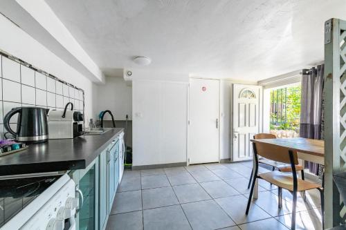 une cuisine avec une table et un comptoir dans l'établissement Appartement Cosy - Proche Disneyland - Paris - RER, à Noisy-le-Grand