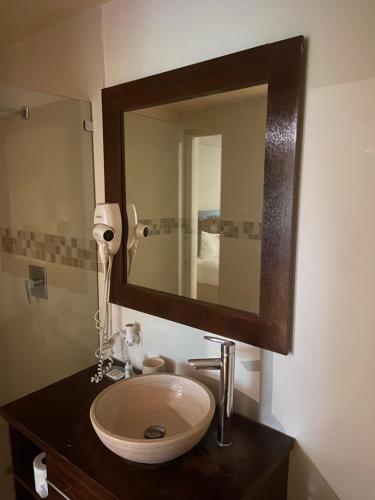 a bathroom with a sink and a mirror at Cacao Suites With Pool in Coronado Luxury Club Golf & Beach in Chame