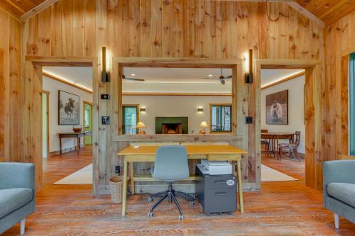a room with a desk and chairs in a house at Riverfront Hideaway in Keene Walk to Town! in Keene