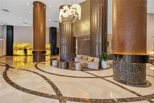 a lobby with columns and couches in a building at Deluxe Studio Ocean View Premium Amenities in Sunny Isles Beach