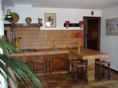 a kitchen with a wooden counter top and a table at Villa St Michel in Brando